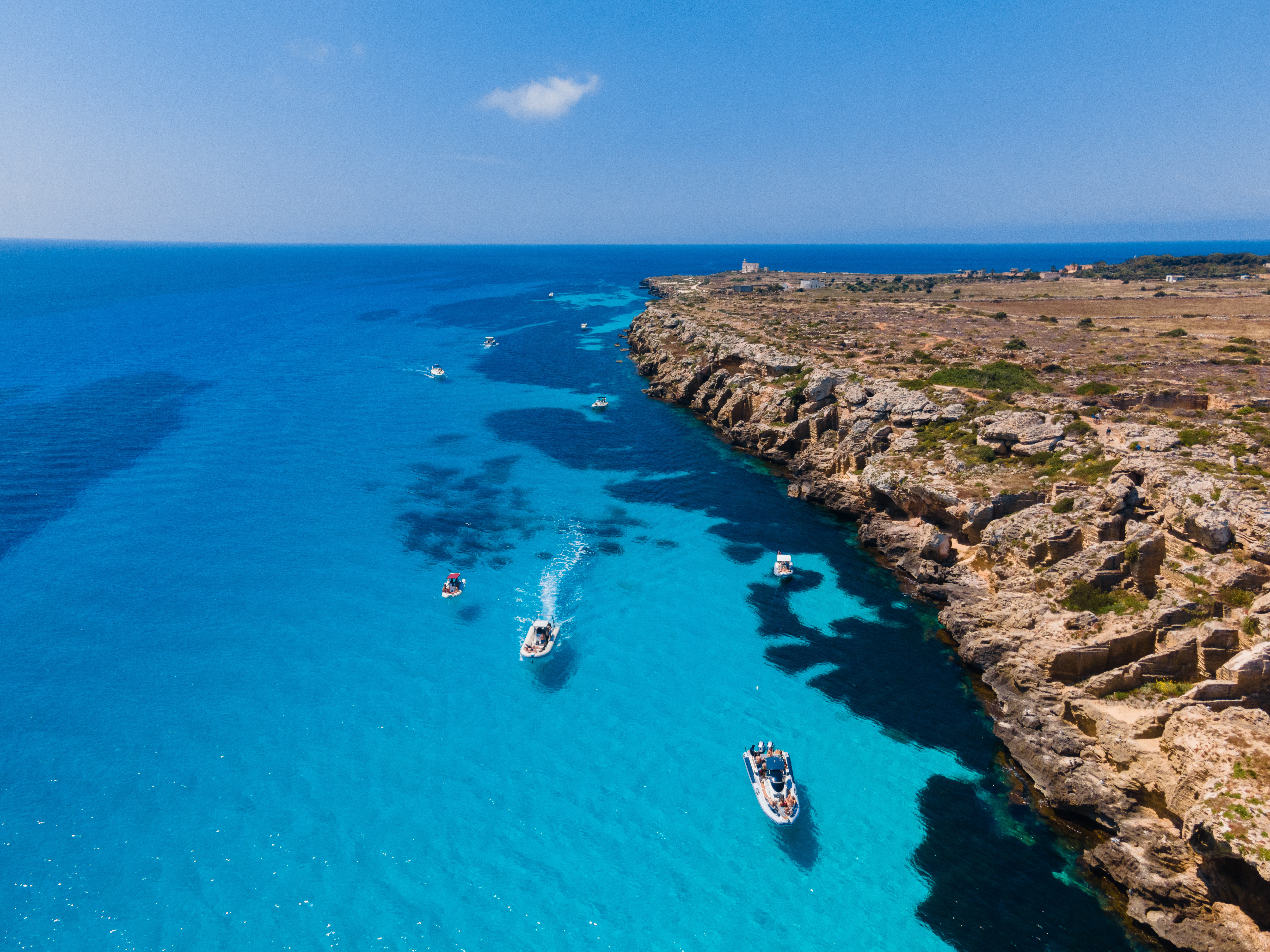 Costa di Favignana vista dall'alto con mare turchese e barche